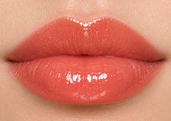 JJ Luxe Cosmetics Heatwave Sheer Peptide Glaze on fair complexion lips in a glossy sheer coral shade
