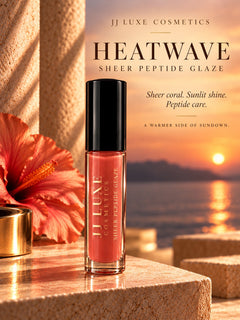 Heatwave Sheer Peptide Lip Glaze by JJ Luxe Cosmetics displayed in a sunset-inspired editorial scene with hibiscus florals and warm golden light.