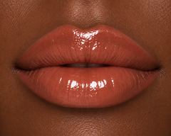 JJ Luxe Cosmetics Last Light Sheer Peptide Glaze on deep complexion lips