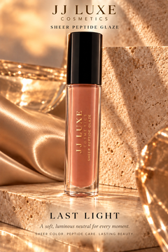 JJ Luxe Cosmetics Last Light Sheer Peptide Glaze in a warm travertine and champagne editorial setting