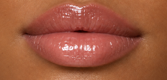 JJ Luxe Cosmetics Moonlit Peptide Lip Glaze on deep tan complexion lips in a glossy sheer blush-pink finish.