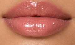 JJ Luxe Cosmetics Moonlit Peptide Lip Glaze on light medium complexion lips in a glossy sheer blush-pink finish.