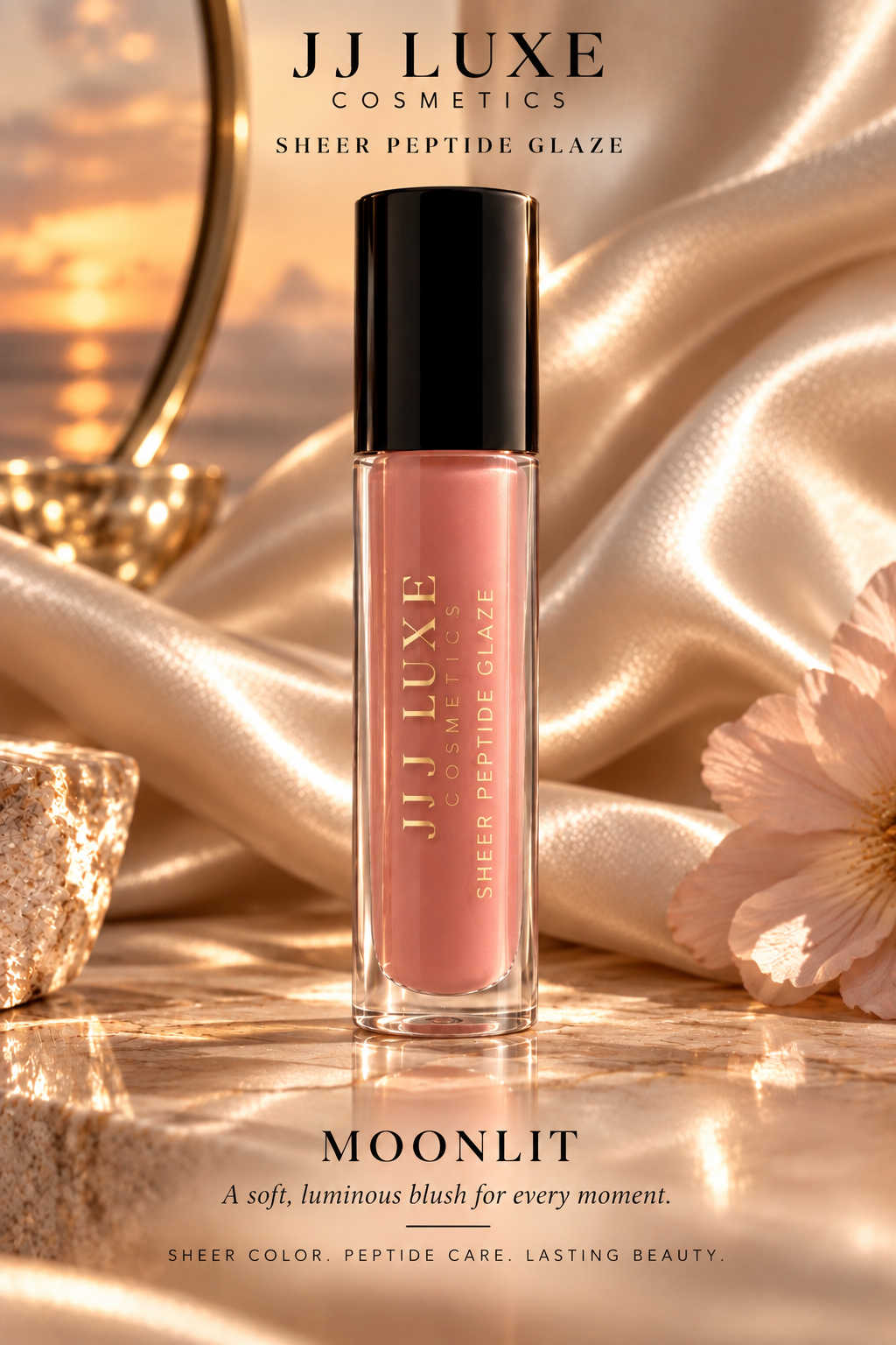 JJ Luxe Cosmetics Moonlit Sheer Peptide Glaze blush pink lip glaze hero on champagne satin at sunset