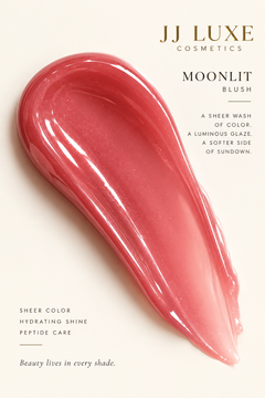 JJ Luxe Cosmetics Moonlit Peptide Lip Glaze glossy sheer blush-pink texture swatch with luminous shine and peptide care messaging.