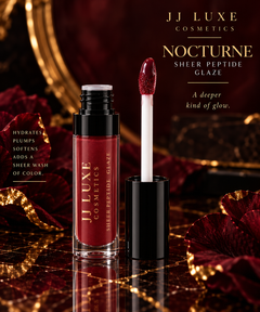 JJ Luxe Cosmetics Nocturne Sheer Peptide Glaze open tube with black neck, black cap and white doe-foot applicator coated in sheer glossy deep burgundy wine-plum, styled on dark marble with gold accents.