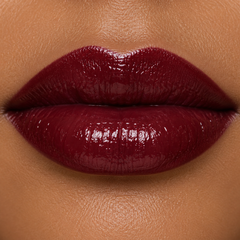 JJ Luxe Cosmetics Nocturne Peptide Lip Glaze on light medium complexion lips, glossy deep burgundy-red lip swatch