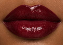 JJ Luxe Cosmetics Nocturne Peptide Lip Glaze on deep tan complexion lips, glossy deep burgundy-red lip swatch
