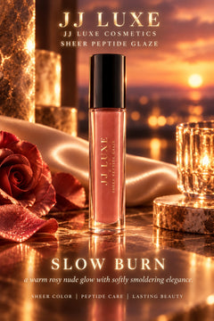 JJ Luxe Cosmetics Slow Burn sheer dusty rose peptide lip glaze in an atmospheric rosy sunset scene with rose petals, champagne satin, candlelit crystal and softly glowing campaign lettering.