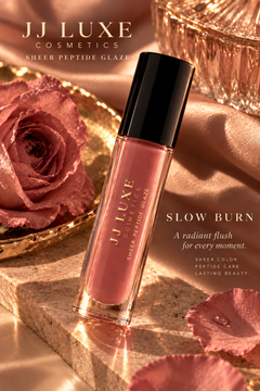 JJ Luxe Cosmetics Slow Burn Sheer Peptide Glaze dusty rose editorial with rose petals, champagne satin, crystal and golden-hour light
